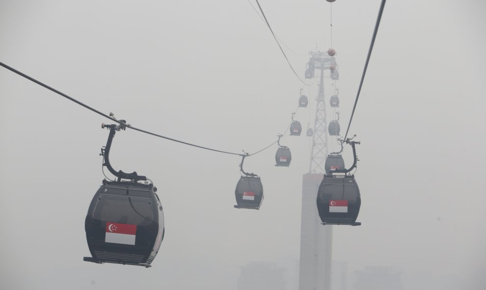 Teleféricos en movimiento hacia la turística isla de Sentosa, envueltos por la neblina en Singapur. REUTERS / Edgar Do