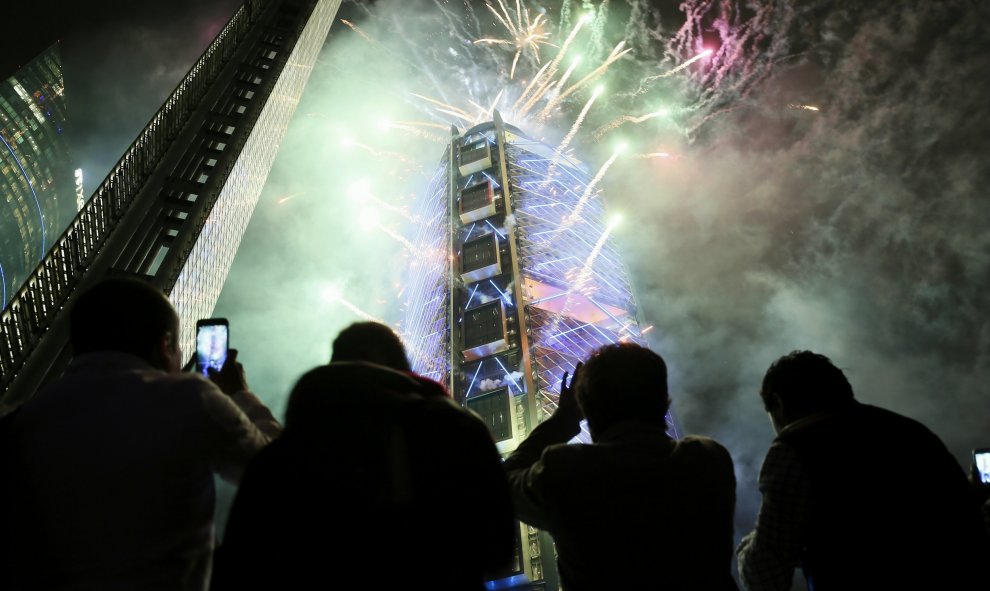 El público observa el edificio BBVA Bancomer envuelto en fuegos artificiales anoche, durante su inauguración en Ciudad de México.EFE/José Méndez