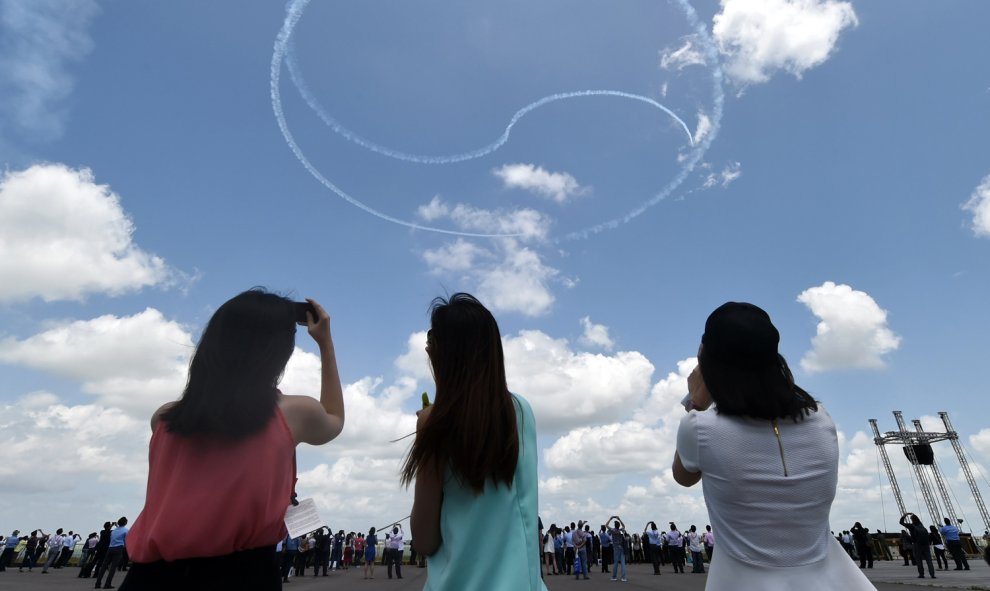 El equipo de acrobacia de las Águilas Negras de Corea del Sur realiza una exhibición aérea formando el logotipo del Ying y Yang durante el Salón Aeronáutico de Singapur en el centro de exposiciones de Changi en Singapur el 16 de febrero de 2016. AFP PHOTO