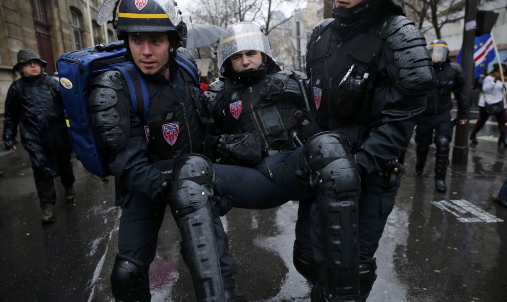 Los antidisturbios sacan a un compañero de la manifestación en París, durante los enfrentamientos con los estudiantes y obreros./REUTERS