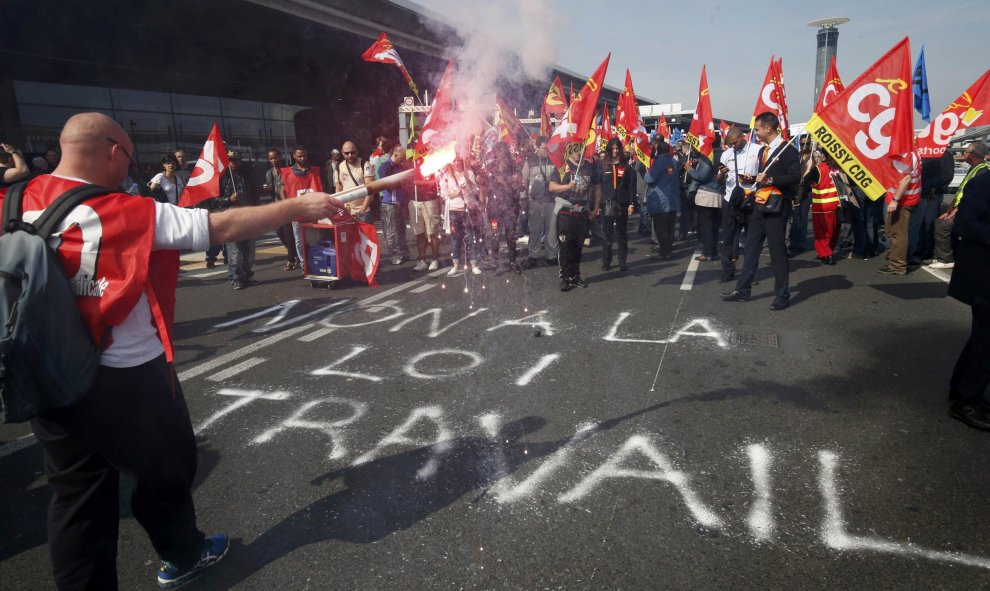 Huelguistas del aeropuerto francés de Roissy portan banderas del sindicado galo CGT durante una manifestación contra la reforma laboral cerca de París, Francia.REUTERS/Philippe Wojazer