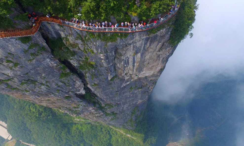 Un grupo de gente camina sobre la plataforma de un mirador en Zhangjiajie, en la provincia de Hunan, China. REUTERS/Stringer