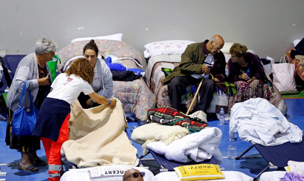 Varias personas que han perdido su hogar por el terremoto pasan la noche en un polideportivo, en Amatrice, Italia.- REUTERS/Ciro De Luca