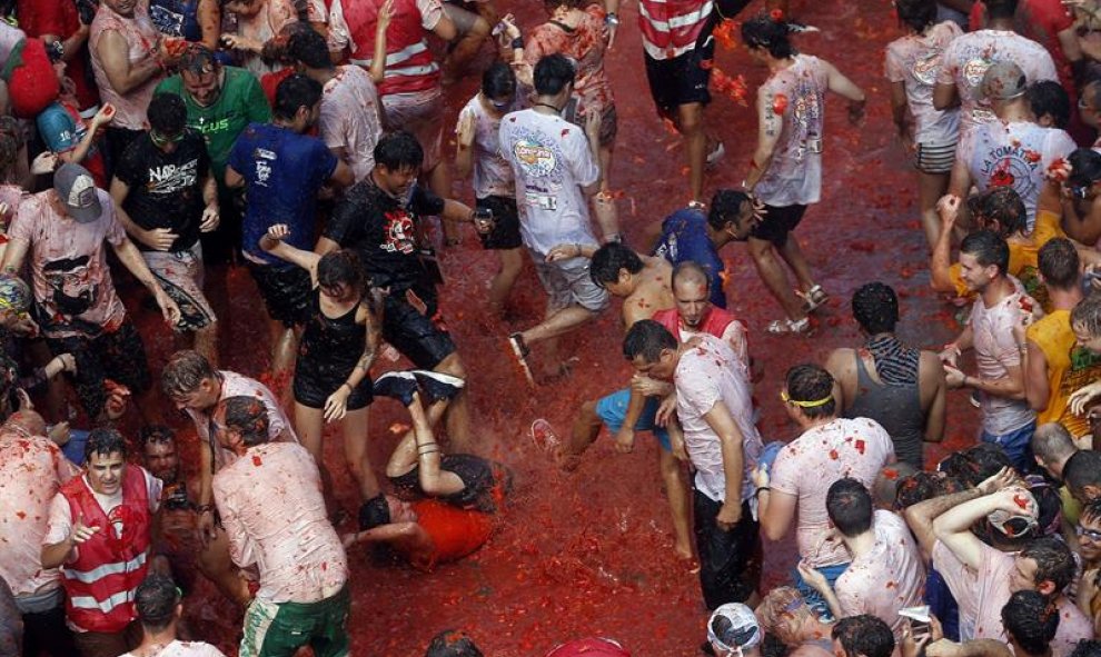 Miles de personas se lanzan tomates en la tradicional celebración. EFE/Kai Forsterling