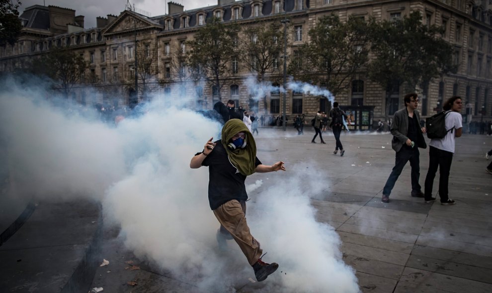 Un manifestante devuelve un bote de gas de lacrimógeno durante una manifestación contra la nueva reforma laboral en París.- EFE/Ian Langsdon