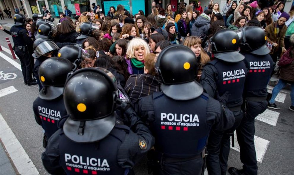 Efectivos de los Mossos d'Esquadra desalojan a un grupo de mujeres que cortaban la Gran Via de Barcelona a la altura de la calle Urgell. EFE/Quique García