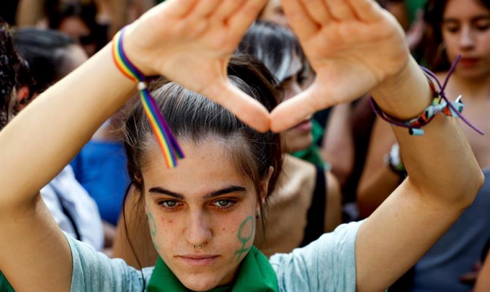 Decenas de personas se suman al "pañuelazo" internacional a favor del aborto legal en Argentina frente a la embajada de ese país en Madrid. / EFE