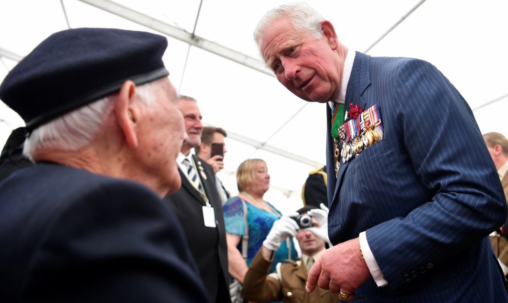El príncipe Carlos de Gales (d) habla con un veterano durante la ofrenda floral realizada en el Cementerio de la Commonwealth | EFE