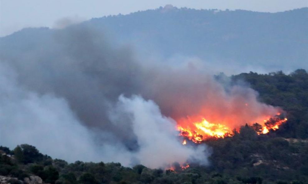 Vista del incendio que se ha declarado esta tarde en la comarca tarraconense de Ribera d'Ebre que afecta ya a más de 2.500 hectáreas y avanza sin control, hasta el extremo de que los Bomberos de la Generalitat han solicitado la ayuda de la Unidad Militar