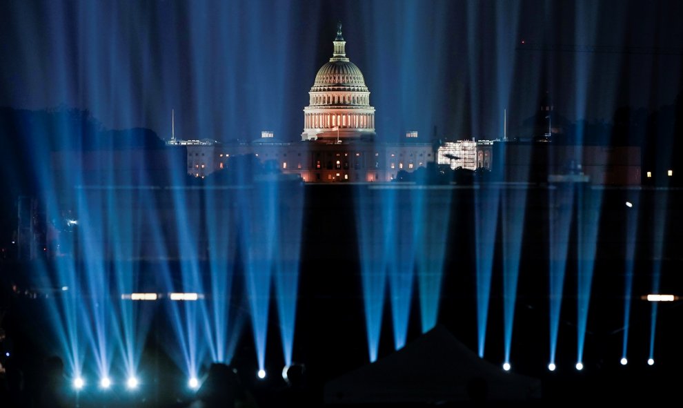 El Capitolio de los EEUU detrás de las luces que proyectan una imagen del cohete Saturn V. Reuters