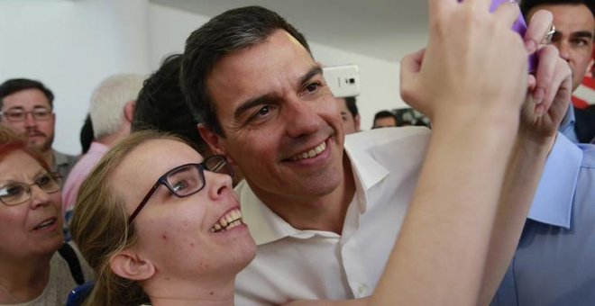 El secretario general del PSOE, Pedro Sánchez, se hace una fotografía con una simpatizante durante el acto electoral con las Juventudes Socialistas, en el Centro Cultural Tomás y Valiente, en la localidad madrileña de Fuenlabrada./ EFE