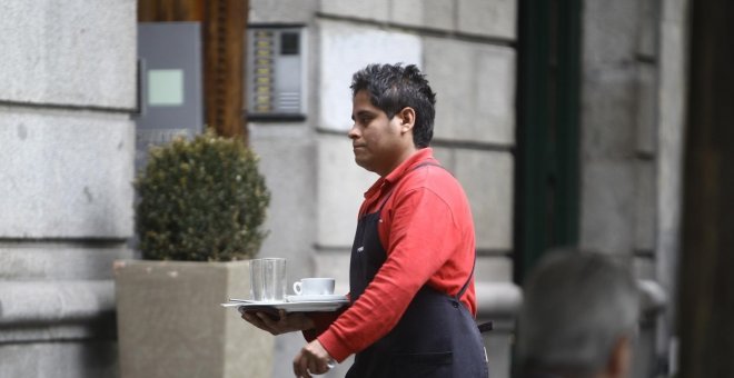 Un camarero extranjero atiende una terraza en un bar en el centro de Madrid. E.P.