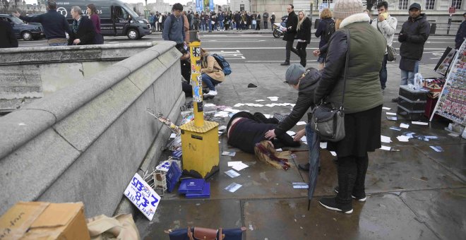Una mujer yace en el suelo tras el ataque cerca del Parlamento de Londres. REUTERS/Toby Melville