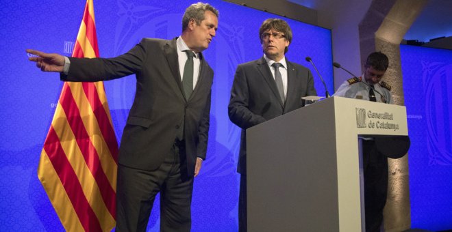 El presidente catalán, Carles Puigdemont (c), junto al conseller de Interior, Joaquim Forn (i), y el mayor de los Mossos d'Esquadra, Josep Lluís Trapero (d), durante la rueda de prensa en la que ha anunciado que los Mossos d'Esquadra han abatido a Younes