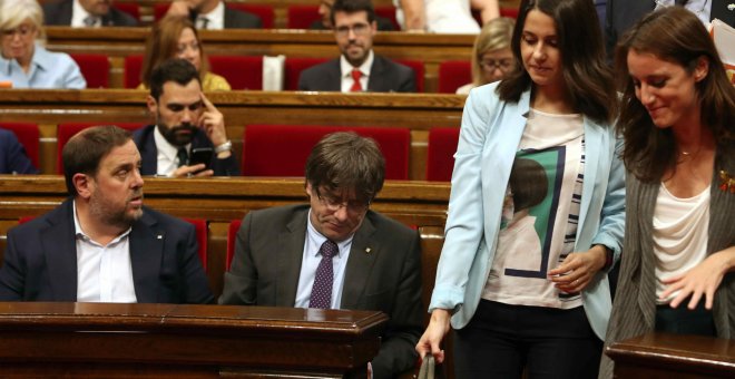 Las diputadas Inés Arrimadas, de Ciudadanos, y Andrea Levy, del PP, pasan junto a los escaños del president de la Generalitat, Carles Puigdemont, y del vicpresidente, Oriol Junqueras, en Parlament de Catalunya. EFE/Toni Albir