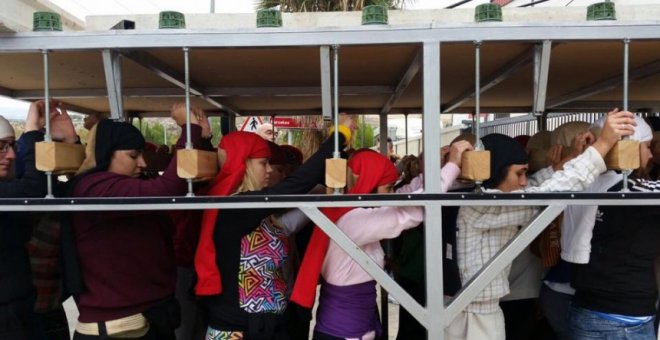 Costaleras ensayan para sacar un paso religioso durante la Semana Santa.