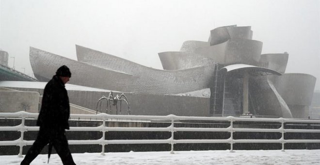 El museo Guggenheim de Bilbao, cubierto de nieve, donde hoy la capital vizcaína amanecido cubierta de nieve, donde afectado al tráfico y a colegios. / EFE