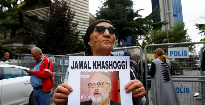 Un activista por los derechos humanos enseña una foto del periodista desparecido Khashoggi durante una protesta a las puertas del consulado saudí - REUTERS/Osman Orsal