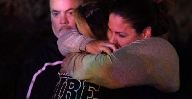 Una mujer que ha huido del lugar del tiroteo, que ha causado al menos 11 heridos, en el Borderline Bar and Grill, abraza a sus familiares en la localidad de Thousand Oaks, California, Estados Unidos, hoy 8 de noviembre de 2018. EFE/ Mike Nelson