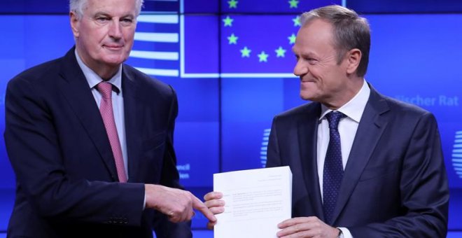 Michel Barnier entrega el borrador del acuerdo del brexit a Donald Tusk en Bruselas. / EFE