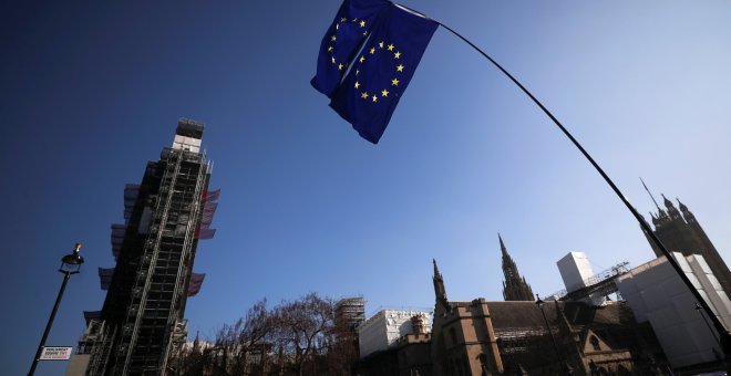 EU flags are seen outside of the Houses of Parliament in London