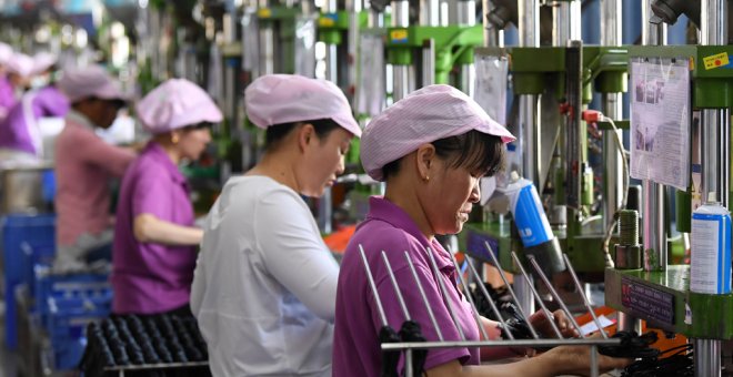 Mujeres trabajadores en una línea de producción de cable de datos en una fábrica en Xinyu, provincia de Jiangxi, China. REUTERS / Stringer