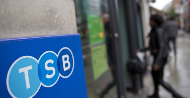 Una mujer entra en una sucursal del banco TSB en Londres. REUTERS/Neil Hall