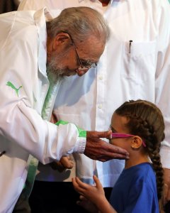 El líder cubano Fidel Castro saluda a una niña durante el acto oficial de celebración de sus 90 años en el Teatro Karl Marx de La Habana. EFE