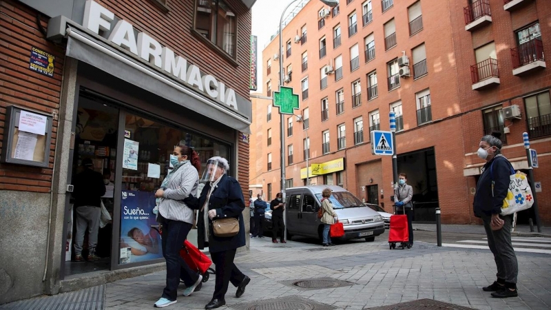 Varias personas hacen cola manteniendo la distancia de seguridad en una farmacia de Madrid. / EFE - DAVID FERNÁNDEZ