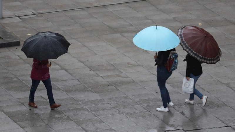 Escolares se protegen de la lluvia con paraguas en Bilbao. EFE/LUIS TEJIDO/Archivo