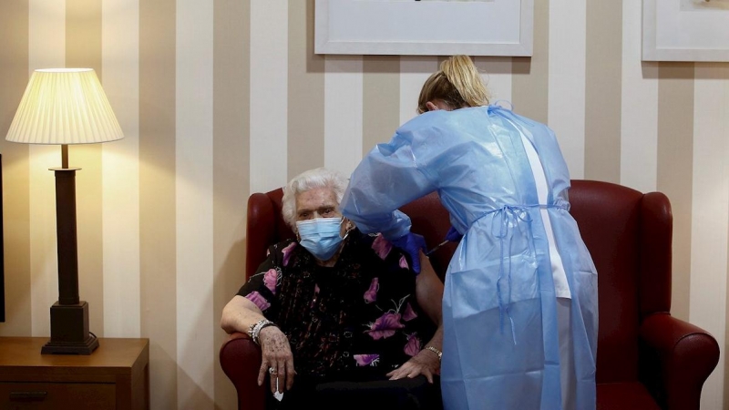 Personal sanitario administra a Antonia Gil (i) de 92 años la segunda dosis de la vacuna contra el Covid-19 de Pfizer-BioNTech en la residencia DomusVi Sabadell Ciutat.