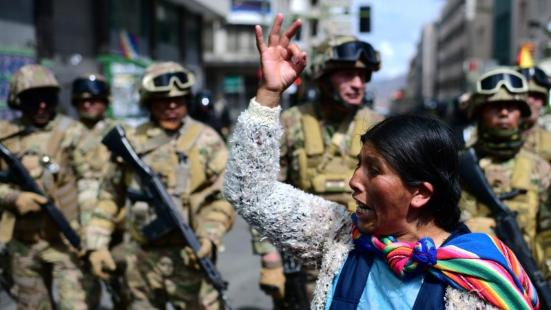 13/07/2022 - Una mujer indígena boliviana, partidaria del expresidente boliviano Evo Morales, gesticula frente a soldados durante una protesta contra el Gobierno interino en La Paz el 15 de noviembre de 2019.