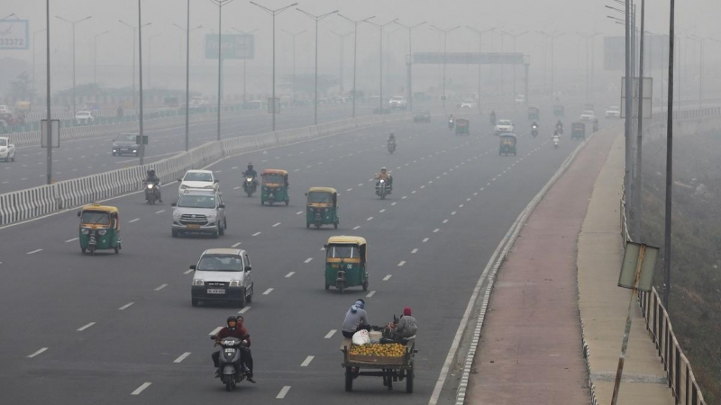 02/12/2021 Vehículos circulan envueltos en una nube de contaminación por una carretera de Nueva Delhi, en la India