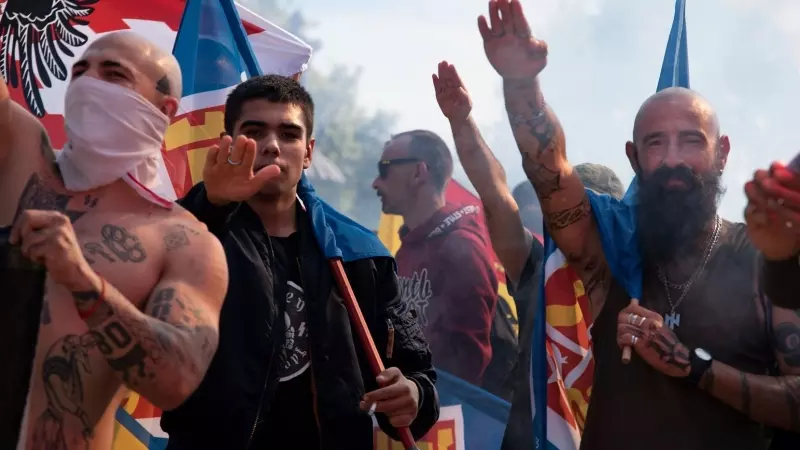 12 October 2022, Spain, Barcelona: Neo-Nazis make the fascist salute at a rally of right-wing extremists on the Spanish national holiday.