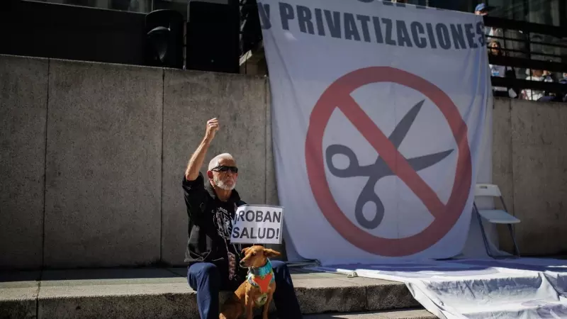 Un manifestante sostiene un cartel que dice 'Roban salud' en la 98ª Marea Blanca por la Sanidad Pública, en la plaza de Juan Goytisolo, a 19 de marzo de 2023, en Madrid, (España).
