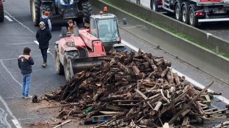 Los agricultores franceses apilan madera en la autopista A4 para bloquear los accesos a París.