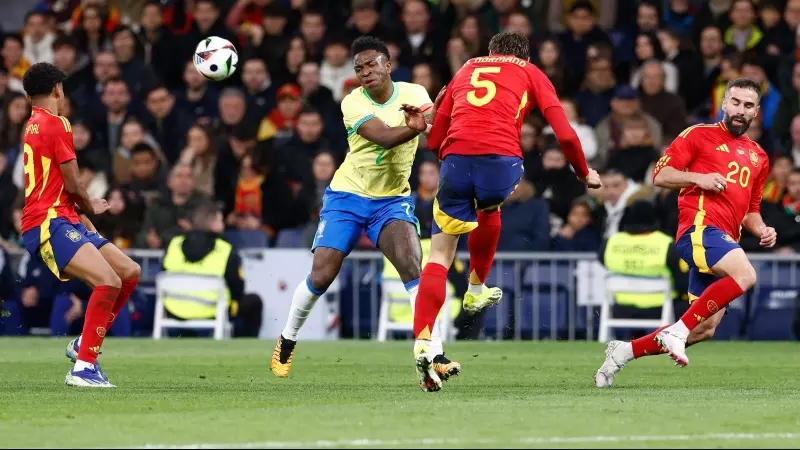 Vinicius Junior of Brazil and Robin Le Normand of Spain in action during the international friendly football match played between Spain and Brazil at Santiago Bernabeu stadium