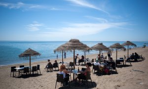 Varias personas en un chiringuito de una playa de Málaga