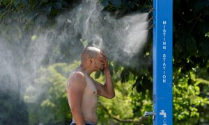 Un hombre se refresca en una fuente pública en Vacouver, Canadá, durante la ola de calor de junio de 2021.