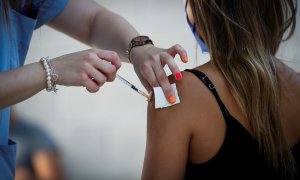 Una joven recibe la vacuna contra la covid-19 este martes en la plaza de toros de Illumbe de San Sebastián. El servicio vasco de salud, Osakidetza, ha iniciado hoy la vacunación masiva contra la covid-19 de jóvenes de entre 19 y 26 años.