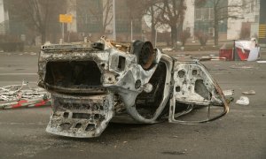 Un vehículo quemado en una plaza cerca de un barrio administrativo en el centro de Almaty el 6 de enero de 2022.