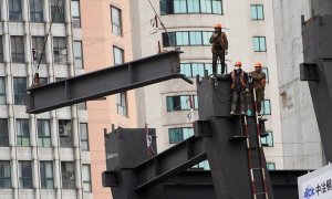 Varios trabajadores en unas vigas de una construcción en Shanghai. REUTERS/Aly Song