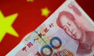 El yuan, moneda del país, bajo la bandera de China.