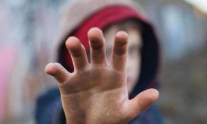 Un niño extiende su mano contra los abusos.