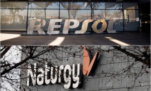 Los logos de Repsol y de Naturgy en sus respectivas sedes en Madrid. REUTERS