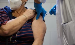 Un enfermero vacuna a una mujer en el Centro de Salud de Alameda de Osuna- 17/10/2022