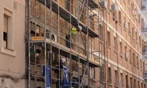 Un trabajador subido a los andamios de una obra, a 17 de mayo de 2023, en Barcelona.