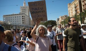 Una mujer sostiene una pancarta durante una manifestación en defensa de la sanidad pública, a 25 de marzo de 2023, en Málaga.