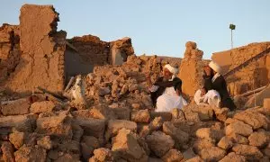 Residentes afganos sentados en una casa dañada tras el terremoto en la aldea de Sarbuland en Zendeh Jan, distrito de la provincia de Herat, el 7 de octubre de 2023.