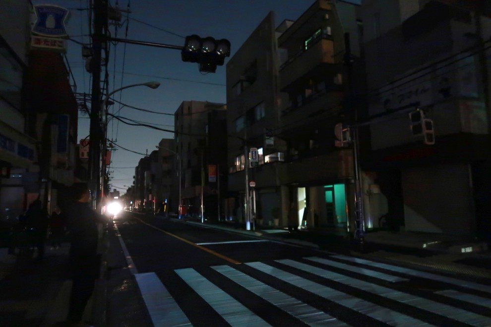 Una calle se oscurece debido a la escasez de electricidad debido a un fuerte terremoto en Musashino, suburbios de Tokio, Japón, a finales del 16 de marzo de 2022.
